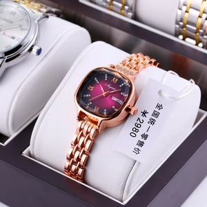 Detail of luxury rose gold square watch with purple gradient dial and date window