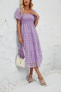 Detail of square neckline and smocked bodice on a light purple tiered midi dress