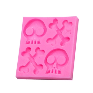 Pink silicone mold with skull and crossbones designs for Halloween fondant and baking