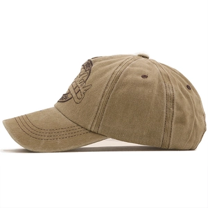 Detail of 3D embroidered logo on khaki washed cotton baseball cap with curved brim