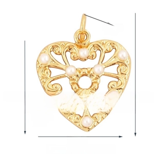 Detail of vintage heart pendant with gold plating, white pearls, and filigree scrollwork