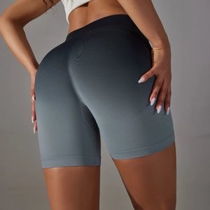 Macro view of gradient seamless high-waist yoga shorts with ribbed compression texture