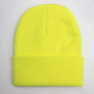 Detailed knit texture of a bright neon yellow winter beanie with warm elastic fabric
