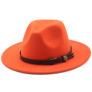 Detail of orange wool fedora with black leather band and silver flower ornament