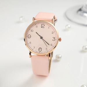 Elegant pink quartz watch for women with rose gold case and leather strap on white pearl background