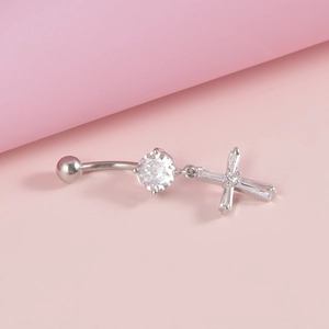 Detailed view of silver navel ring featuring a sparkling zircon cross pendant
