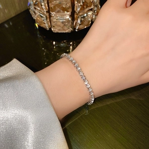 Close-up of elegant tennis bracelet with round cubic zirconia on a female wrist