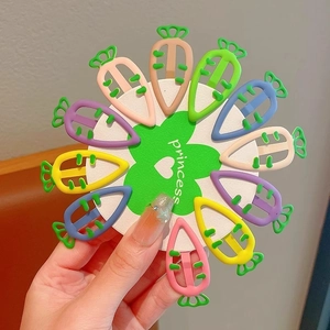 Set of 12 colorful carrot-shaped metal BB hair clips for kids on a princess card