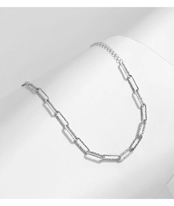 Close-up of minimalist S925 sterling silver paperclip chain bracelet on white background