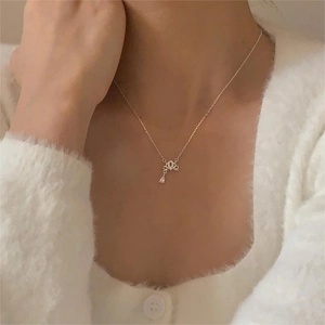 Detail of 925 sterling silver crown necklace with water-drop cubic zirconia on neck