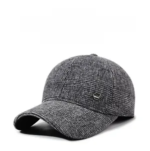 Detail showing high-quality grey-black plaid fabric and metal hexagon logo on baseball cap