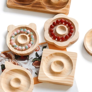 Detail view of assorted creative wooden jewelry trays for bracelets with natural wood grain