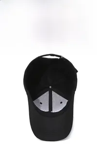 Detail view of black baseball cap interior showing breathable mesh layer and metal buckle