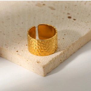 Macro detail of 18k gold plated stainless steel ring with honeycomb texture on stone