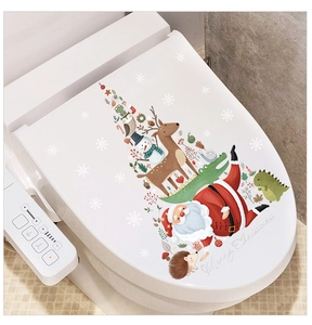 Detail of Christmas toilet lid stickers featuring Santa Claus and reindeer characters
