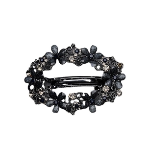 Vintage floral hair clip in black metal with champagne rhinestones on white background