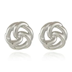 Macro shot of silver knot stud earrings with polished geometric triple loop design