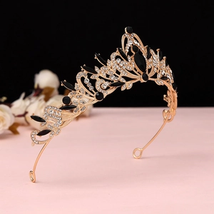 Macro detail of Baroque gold crown with black gems and sparkling crystals for weddings