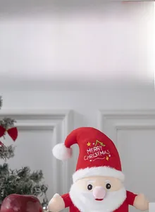 Detail of Santa plush toy with Merry Christmas embroidery and soft velvet texture