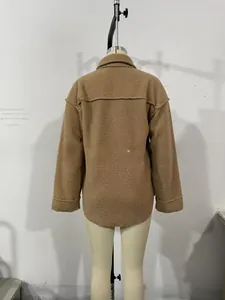 Detail view showing back seams and curved hem of brown faux fur lamb wool jacket