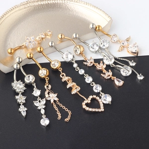 Set of gold and silver navel button rings with heart and star zircon pendants