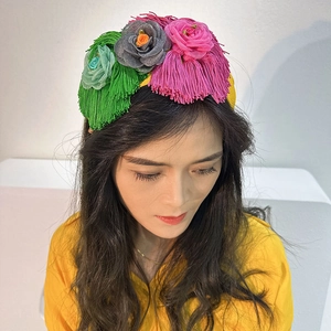 Detail of handmade fabric floral headband with colorful tassels worn by a model