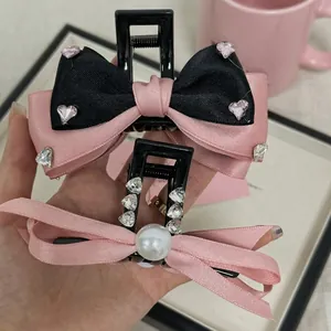 Pink and black bow hair claw clips with heart rhinestones and pearls for women