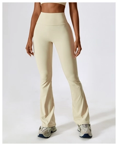 Detail of high waisted cream flare yoga pants showing slim fit and elastic fabric texture