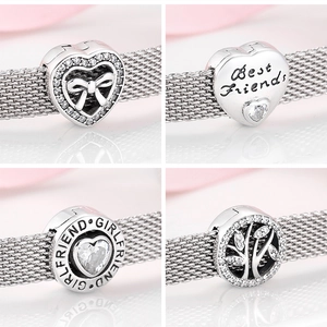 Detailed close-up of S925 sterling silver charms with engraved text and cubic zirconia
