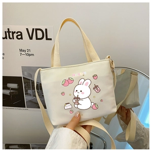 Cream canvas kids crossbody bag featuring a cute cartoon rabbit drinking milk tea