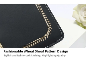 Close-up of golden wheat embroidery and contrast stitching on a black textured handbag