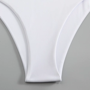 Detail of white bikini bottom featuring breathable mesh lining and seamless fabric texture