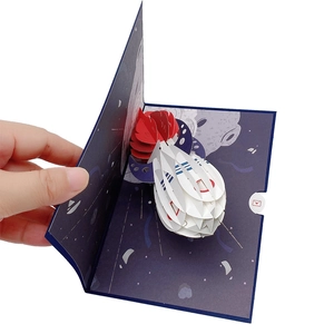 Detailed 3D pop-up birthday card featuring a space rocket launch and dark blue background