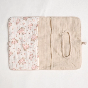 Detailed top view of a quilted cotton baby storage bag with floral print and tissue opening
