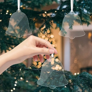 Clear acrylic bell-shaped Christmas tree ornaments with white silk hanging ribbons