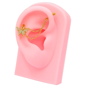 Detail of golden butterfly ear chain with zircon pave and double link chain on a pink ear model