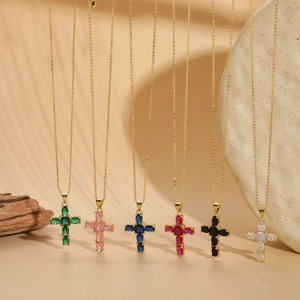 Detail of six gold cross necklaces featuring vibrant oval-cut colorful gemstones