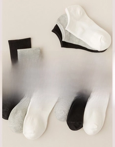 Detailed flat lay of breathable cotton socks in white, black and grey with ribbed cuffs