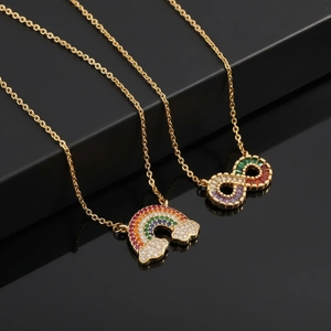 Elegant gold necklace with rainbow zircon infinity and cloud pendants on a black stand