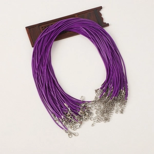 Detail showing purple waxed cord necklaces with silver lobster clasps on wooden stand