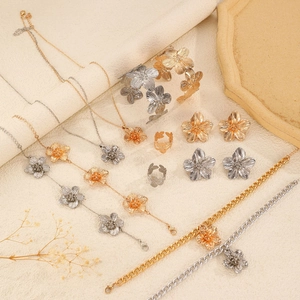 Detail of gold and silver floral textured jewelry set with necklaces and rings