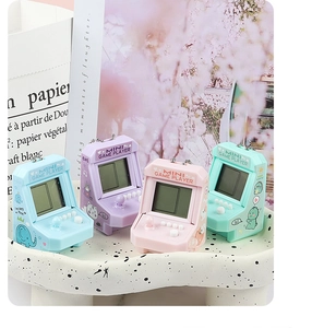 Close-up of retro mini arcade game keychains in blue, purple, pink, and green colors