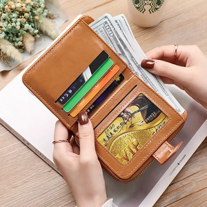 Women's brown soft leather short wallet showing interior card slots and cash compartments