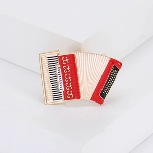 Elegant accordion brooch pin with detailed piano keys and colorful enamel finish