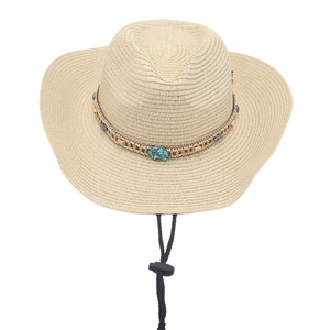 Close-up of woven straw cowboy hat with turquoise beads and adjustable chin strap