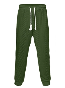 Detail of dark green men's joggers with jacquard fabric texture and white drawstring