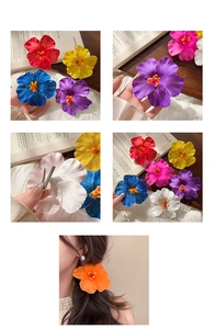 Detail showing colorful hibiscus fabric flower hair clips with silver metal duckbill base