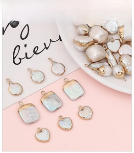 Close-up of assorted baroque pearl charms with 18K gold edges for DIY jewelry making