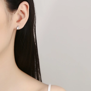 Elegant 925 sterling silver triple star stud earrings worn on earlobe with minimalist style