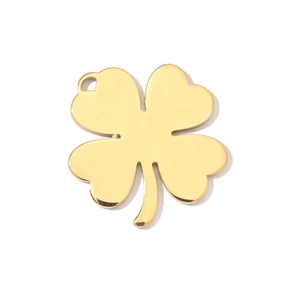 Detailed view of a polished gold clover charm with a compass star for jewelry DIY